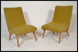 A pair of vintage retro 20th Century lounge / tub chairs, upholstered with a yellow fabric cover,