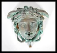 A 19th Century Bronze water feature mask depicting Medusa after the antique discovered in the temple