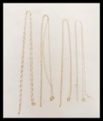 A group of four stamped 9ct gold necklace chains having spring ring clasps to include oval link