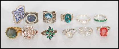 A group of 12 stamped 925 silver ladies dress rings to include a split band ring having a flower