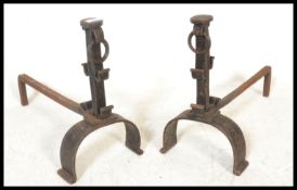 A pair of 19th Century French hand forged wrought iron fire dogs / chennets, raised on scrolled