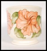 A mid 20th Century Moorcroft tube lined planter on green ground in the Hibiscus pattern. Moorcroft