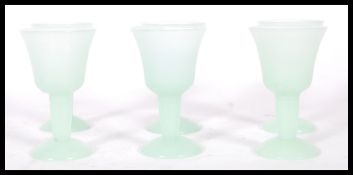 A set of six 20th Century green jadeite goblets of small proportions having bell shaped bowls raised
