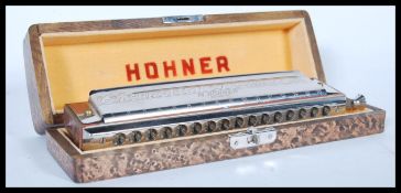 A vintage cased M. Hohner ' the 64 Chromonica ' German professional harmonica, in 4 chromatic
