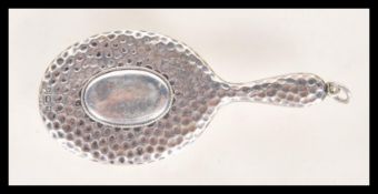 A hallmarked silver miniature ( dolls house ) dressing table hand mirror, having hand beaten