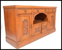 A Victorian golden oak sideboard dresser. Raised on a plinth base with a series of short drawers