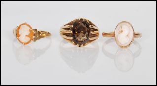 A group of three 9ct gold ladies rings to include a hallmarked cameo ring set with a oval cameo