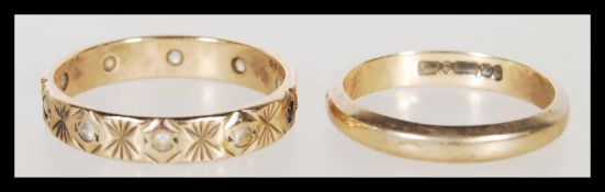 A hallmarked 9ct gold band ring ( size K ) together with a 9ct gold hallmarked eternity ring set