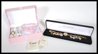 A Franklin Mint Elvis Presley wrist watch having a round mother of pearl face of a yellow metal