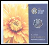 The Royal Mint uncirculated 2009 Kew Gardens 50p coin, mounted to its original presentation card.
