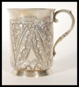 A 19th Century Victorian silver hallmarked Christening cup having repousse foliate detailing,