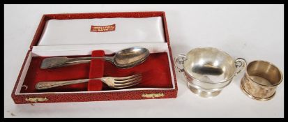 A cased silver hallmarked spoon and fork christening set retailed by Mallorys of Bath together