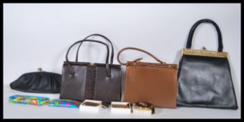 A small group of handbags and compacts to include three shoulder bags of similar design all having