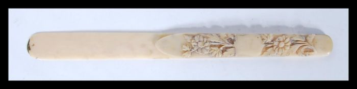 A 19th Century carved ivory page turner bookmark having carved floral decoration and an unmarked