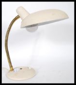 A vintage mid 20th Century gooseneck desk lamp, set to a circular base with inset switch gilt