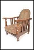 A 1930's Art Deco oak framed fireside reclining armchair. The chair with upholstered seat and back
