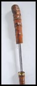 A 20th Century walking sword stick cane having bamboo root ball top and brass band. The handle pulls