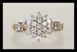 A hallmarked 9ct gold ladies cluster ring set with a central cluster of white stones and white