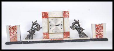 A 1930's Art Deco French 3 piece marble clock garniture set. The square shaped clock with inset