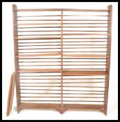 An unusual 20th century oak open  bookcase having a configuration of adjustable shelves on plinth