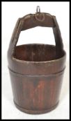 A 19th Century Chinese coopered wooden elem water pail/ bucket, being wrought iron banded.