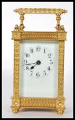 A 20th Century brass carriage clock having four glass panelled sides exposing the mechanism to the