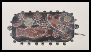 A silver hallmarked Victorian friendship brooch of rectangular form, having gold floral and bird
