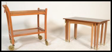 A retro 20rth Century teak wood buffet / serving two tier trolley raised on casters together with