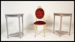 A pair of painted demi lune occasional side tables together with a red velour upholstered Louis