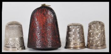 A group of three silver hallmarked thimbles to include a Charles Horner thimble within a fitted Hogg