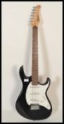 A 20th Century Cort G Series six string electric guitar, serial number 020906190, black finish to