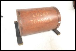 An original vintage mid century Tombola machine of wooden construction raised on H wooden base