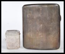 A early 20th Century silver hallmarked cigarette case and vesta case. The cigarette case made by S M
