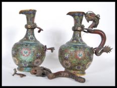 A pair of 19th Century Qing dynasty Chinese brass cloisonne wine jugs having enamelled floral sprays