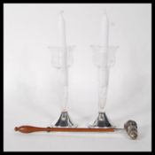 A pair of vintage glass candlestick holders of octagonal form with bell shaped sconces being