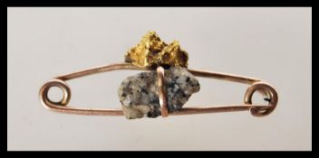 A 9ct gold ladies safety pin brooch having a preci