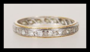 A stamped 18ct gold two tone eternity band ring being set with white stones. Weight 2.0g. Size K.