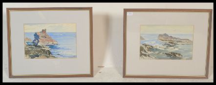 A pair of 20th century watercolour paintings of coastal rocky scenes being signed to the corner