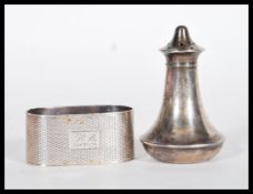 A silver hallmarked pepperette of curved tapering form with pierced lid to top (hallmarked