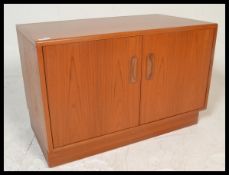 A retro 20th Century teak wood low sideboard / music cabinet by G Plan, two doors opening to
