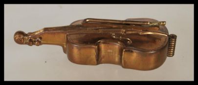 A 20th Century novelty sewing tape measure in form of a cello, having the bow as the winding