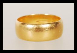 A hallmarked 22ct gold wedding band ring of typical form. Hallmarked Birmingham 1965. Weight 7.4g.