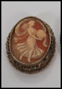 Two 20th Century silver cameo brooches to include a carved conch shell cameo depicting a maiden