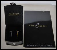 A pair of 9ct white gold and diamond earrings with post backs. The drop earrings adorned with