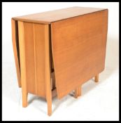 A 20th century retro vintage teak wood drop leaf / gate leg table having an unusual shape and