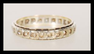 A stamped 9ct gold two tone eternity ring set with white stones to the band. Weight 3.1g. Size S.
