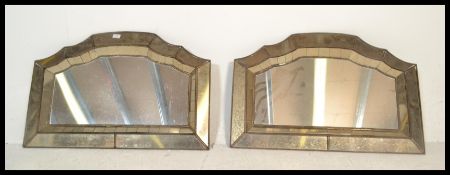 A pair of unusual Venetian style wall mirrors. Each of lozenge form with recessed angled cushion