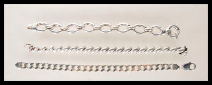 A selection of three stamped 925 silver bracelets to include a flat link bracelet having a lobster