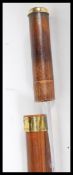 A 20th Century bamboo walking sword stick, having flat brass top and brass band. The handle pulls
