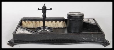 An early 20th Century silver and ebony wood dressing table set consisting of fitted tray, clothes